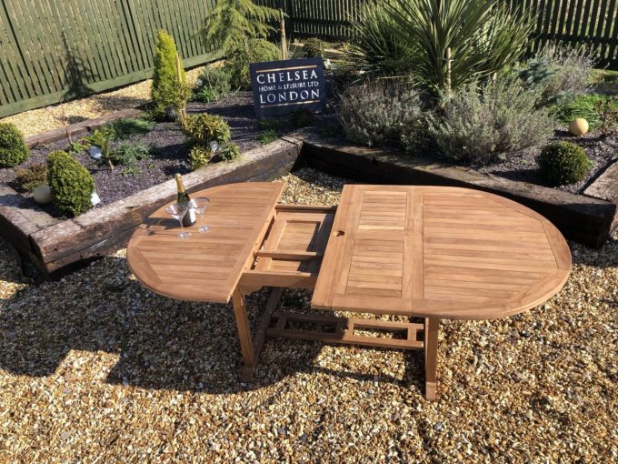 Teak extending table with 8 stacking chairs