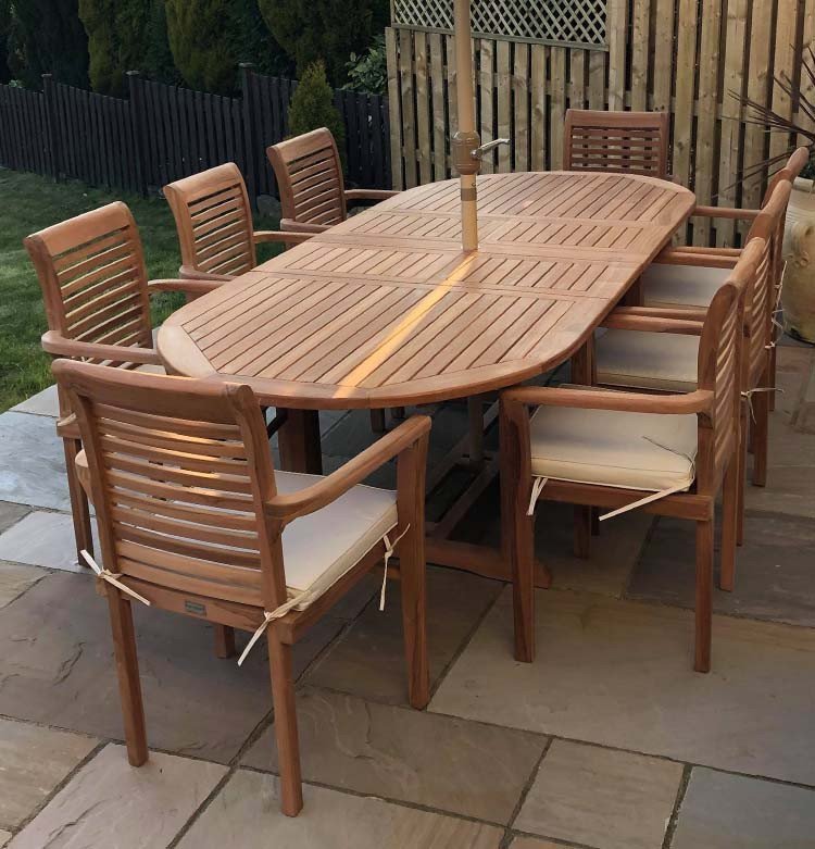 This teak garden dining set is amazing value - double extending table 1.8m to 2.4m, 8 x teak stacking chairs, free 3m parasol and cushions